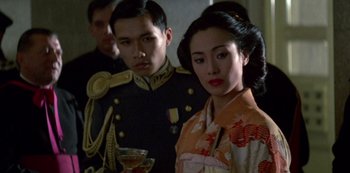 Movie still from “The Last Emperor” (1987), directed by Bernardo Bertolucci – A man and a woman dressed in traditional japanese clothing; Medium shot, Low angle