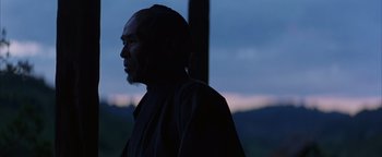 Movie still from “The Last Samurai” (2003), directed by Edward Zwick – A man standing in front of a window at night; Close Up shot, Low angle