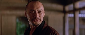 Movie still from “The Last Samurai” (2003), directed by Edward Zwick – A man with a shaved head and a goatee is looking at the camera; Close Up shot, Low angle
