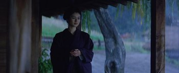 Movie still from “The Last Samurai” (2003), directed by Edward Zwick – A woman wearing a purple robe standing under a tree; Medium shot, Low angle