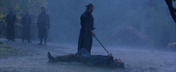Movie still from “The Last Samurai” (2003), directed by Edward Zwick – A man in a black robe standing next to another man in a black robe; Wide shot, Low angle