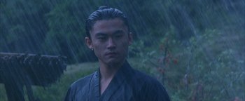 Movie still from “The Last Samurai” (2003), directed by Edward Zwick – A man in a black robe standing in the pouring rain; Close Up shot, Low angle