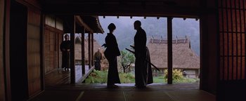 Movie still from “The Last Samurai” (2003), directed by Edward Zwick – A man and a woman standing in front of a building; Wide shot, Low angle