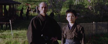 Movie still from “The Last Samurai” (2003), directed by Edward Zwick – A man and a young boy in traditional japanese garb; Medium shot, Low angle