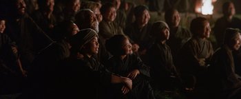 Movie still from “The Last Samurai” (2003), directed by Edward Zwick – A group of people sitting in a room watching something; Medium shot, Over the shoulder angle