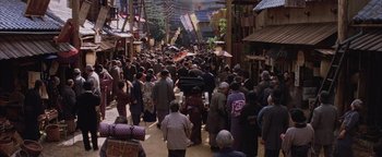 Movie still from “The Last Samurai” (2003), directed by Edward Zwick – A crowd of people walking down a street; Extreme Wide shot, High angle