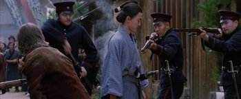 Movie still from “The Last Samurai” (2003), directed by Edward Zwick – A man in a blue robe and a man in a black jacket and a man in a blue robe and a man in a black jacket and a; Medium shot, Over the shoulder angle
