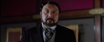 Movie still from “The Last Samurai” (2003), directed by Edward Zwick – A person wearing a suit and tie; Close Up shot, Low angle