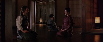 Movie still from “The Last Samurai” (2003), directed by Edward Zwick – Two people sitting on the ground in a room; Wide shot, High angle