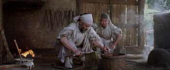 Movie still from “The Last Samurai” (2003), directed by Edward Zwick – Two men are working in an old - fashioned workshop; Medium shot, Low angle
