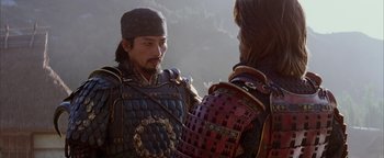 Movie still from “The Last Samurai” (2003), directed by Edward Zwick – A man in a suit of armor talking to another man in armor; Close Up shot, Over the shoulder angle