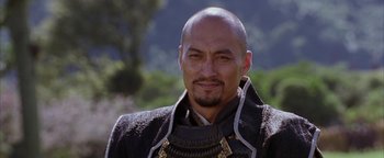 Movie still from “The Last Samurai” (2003), directed by Edward Zwick – A man with a bald head wearing a black jacket; Close Up shot, Low angle
