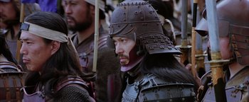 Movie still from “The Last Samurai” (2003), directed by Edward Zwick – A man wearing a helmet and a sword; Close Up shot, Over the shoulder angle