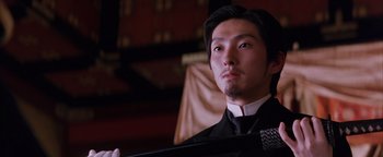 Movie still from “The Last Samurai” (2003), directed by Edward Zwick – A person wearing a suit and tie; Close Up shot, Low angle