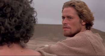 Movie still from “The Last Temptation of Christ” (1988), directed by Martin Scorsese – A person sitting on a couch; Close Up shot, Over the shoulder angle