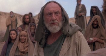 Movie still from “The Last Temptation of Christ” (1988), directed by Martin Scorsese – An old man with a beard and a long white beard; Medium shot, Low angle