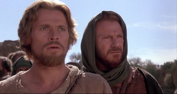 Movie still from “The Last Temptation of Christ” (1988), directed by Martin Scorsese – Two men standing next to each other in the desert; Close Up shot, Low angle