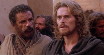 Movie still from “The Last Temptation of Christ” (1988), directed by Martin Scorsese – A group of men standing next to each other in a room; Close Up shot, Over the shoulder angle