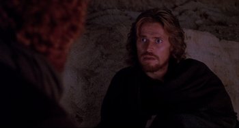 Movie still from “The Last Temptation of Christ” (1988), directed by Martin Scorsese – A man with long blonde hair and blue eyes stares at the camera; Close Up shot, Over the shoulder angle