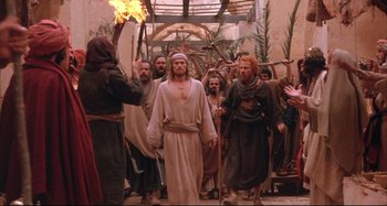 Movie still from “The Last Temptation of Christ” (1988), directed by Martin Scorsese – A group of men in robes walking down a street; Wide shot, High angle