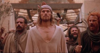 Movie still from “The Last Temptation of Christ” (1988), directed by Martin Scorsese – A group of men standing next to each other; Medium shot, Low angle