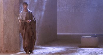 Movie still from “The Last Temptation of Christ” (1988), directed by Martin Scorsese – A man standing in the middle of an empty room; Wide shot, Low angle