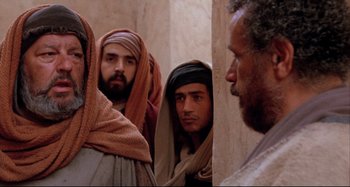 Movie still from “The Last Temptation of Christ” (1988), directed by Martin Scorsese – A group of men standing next to each other; Medium shot, Over the shoulder angle