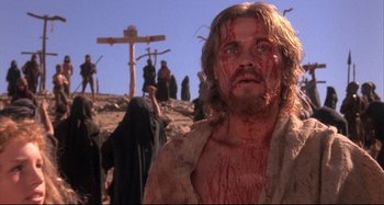 Movie still from “The Last Temptation of Christ” (1988), directed by Martin Scorsese – A man with blood all over his face and chest; Close Up shot, Low angle