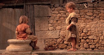 Movie still from “The Last Temptation of Christ” (1988), directed by Martin Scorsese – Two young children playing with a wooden wagon; Wide shot, High angle