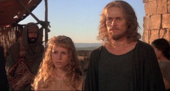 Movie still from “The Last Temptation of Christ” (1988), directed by Martin Scorsese – A man and a woman standing next to each other; Close Up shot, Low angle