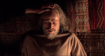 Movie still from “The Last Temptation of Christ” (1988), directed by Martin Scorsese – A man with long white hair and a white beard; Close Up shot, Over the shoulder angle