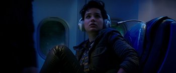 Movie still from “The Last Witch Hunter” (2015), directed by Breck Eisner – A woman with headphones on sitting on a train; Medium shot, Low angle