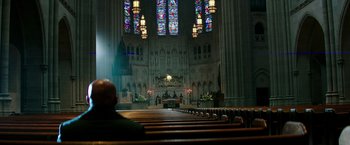 Movie still from “The Last Witch Hunter” (2015), directed by Breck Eisner – A man is sitting in a pew in a church; Extreme Wide shot, High angle