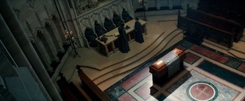 Movie still from “The Last Witch Hunter” (2015), directed by Breck Eisner – A group of people sitting at a table in front of a bench; Extreme Wide shot, High angle