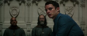 Movie still from “The Last Witch Hunter” (2015), directed by Breck Eisner – A man standing in front of another man in front of a wall; Close Up shot, Low angle