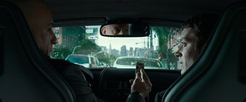 Movie still from “The Last Witch Hunter” (2015), directed by Breck Eisner – A man in the back of a car taking a picture with his cell phone; Close Up shot, Over the shoulder angle