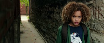 Movie still from “The Last Witch Hunter” (2015), directed by Breck Eisner – A young boy with curly hair wearing a green jacket; Close Up shot, Overhead angle