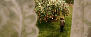 Movie still from “The Last Witch Hunter” (2015), directed by Breck Eisner – A person with a backpack standing in front of a tree; Wide shot, High angle