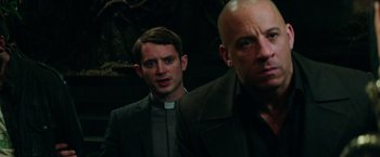 Movie still from “The Last Witch Hunter” (2015), directed by Breck Eisner – A priest and a bald headed man in a dark room; Close Up shot, Low angle