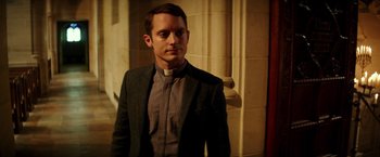 Movie still from “The Last Witch Hunter” (2015), directed by Breck Eisner – A man wearing a suit and standing in front of a building; Medium shot, Over the shoulder angle