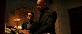Movie still from “The Last Witch Hunter” (2015), directed by Breck Eisner – Two men standing next to each other wearing suits; Medium shot, Low angle