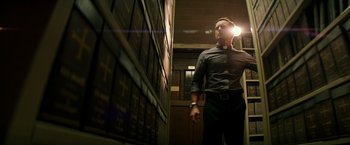 Movie still from “The Last Witch Hunter” (2015), directed by Breck Eisner – A man standing in front of a wall of books; Medium shot, Low angle