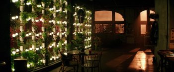 Movie still from “The Last Witch Hunter” (2015), directed by Breck Eisner – A table and chairs in front of a wall covered in lights; Extreme Wide shot, Low angle