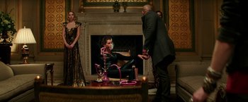 Movie still from “The Last Witch Hunter” (2015), directed by Breck Eisner – A woman sitting on the ground in front of a fireplace; Wide shot, Over the shoulder angle