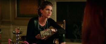 Movie still from “The Last Witch Hunter” (2015), directed by Breck Eisner – A beautiful woman sitting in a chair holding a purse; Medium shot, Over the shoulder angle