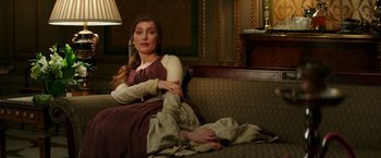 Movie still from “The Last Witch Hunter” (2015), directed by Breck Eisner – A woman sitting on a couch with her arms crossed; Medium shot, High angle
