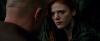 Movie still from “The Last Witch Hunter” (2015), directed by Breck Eisner – A person with red hair looking at the camera; Close Up shot, Over the shoulder angle