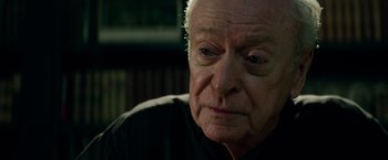 Movie still from “The Last Witch Hunter” (2015), directed by Breck Eisner – An older man looking at the camera while sitting down; Close Up shot, Over the shoulder angle