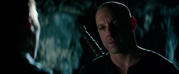 Movie still from “The Last Witch Hunter” (2015), directed by Breck Eisner – A bald man is holding a sword in his hand; Close Up shot, Over the shoulder angle
