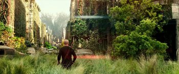 Movie still from “The Last Witch Hunter” (2015), directed by Breck Eisner – A man standing in the grass looking at a building; Wide shot, Low angle